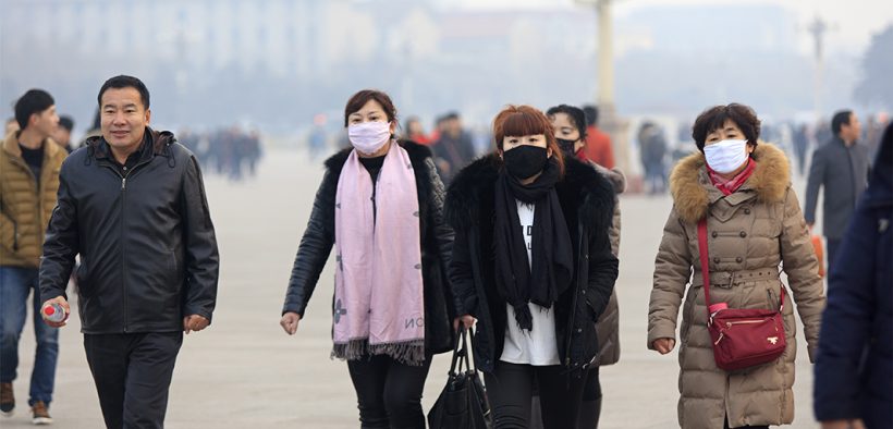 Image of people walking and wearing face masks for Cross Border Air Pollution in Asia blog post
